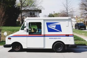 USPS mail delivery truck parked on a residential street