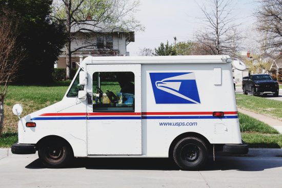 USPS mail delivery truck parked on a residential street
